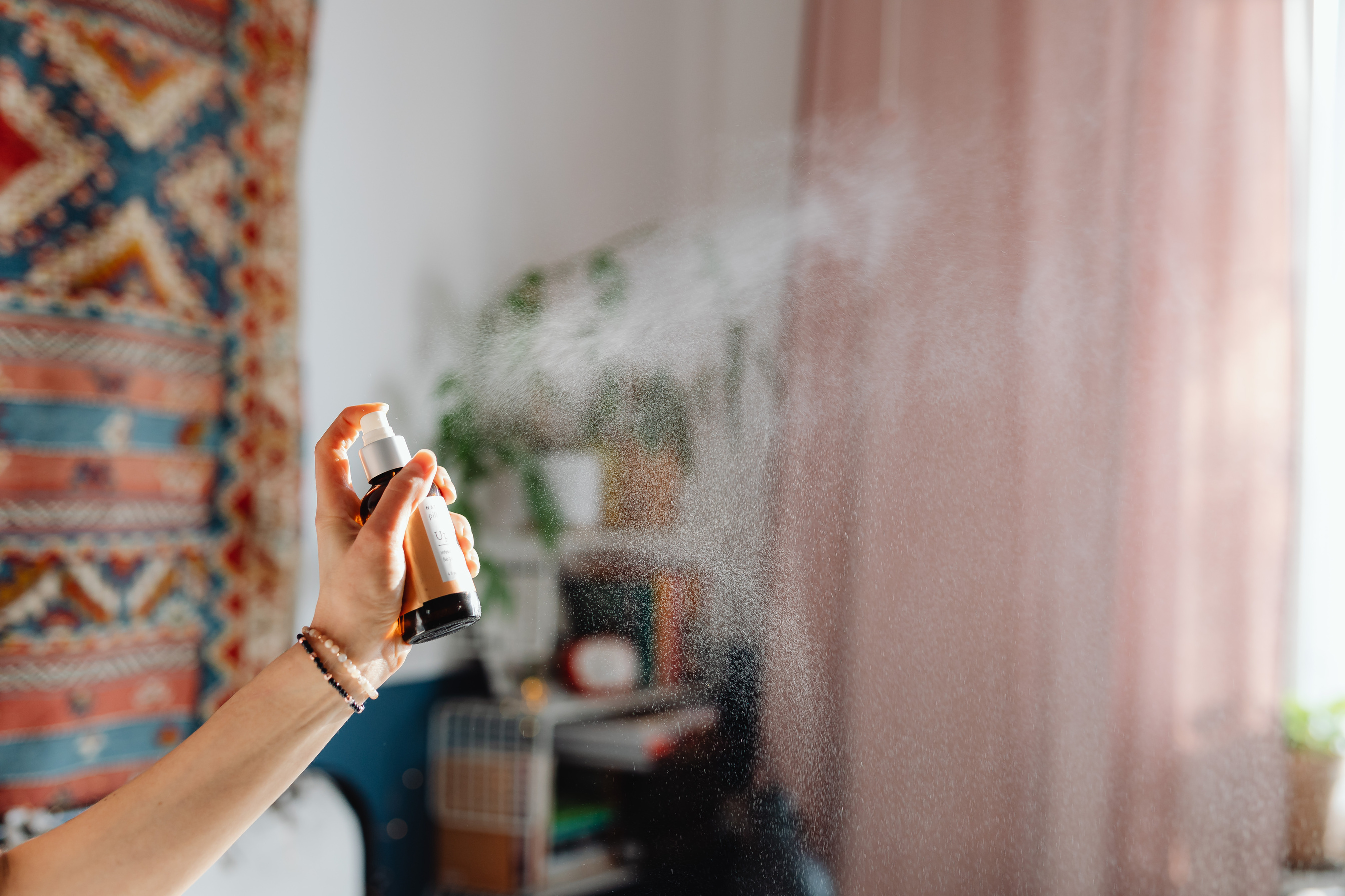 Woman Using Room Spray in her Flat